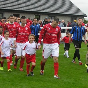 Both teams make their way onto the pitch along with their mascots. Picture: Oliver Fitzpatrick