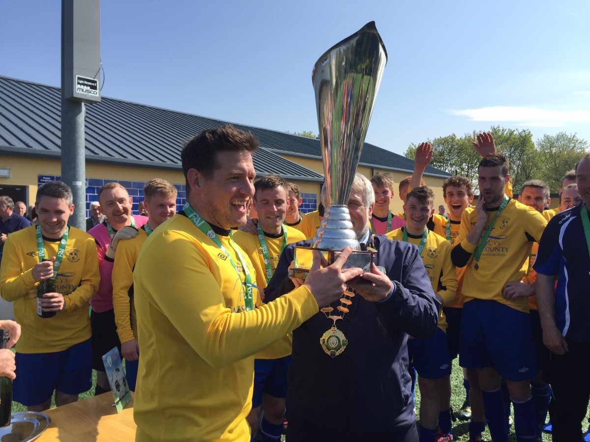 Clare captain Paddy Purcell collects the Oscar Traynor Trophy