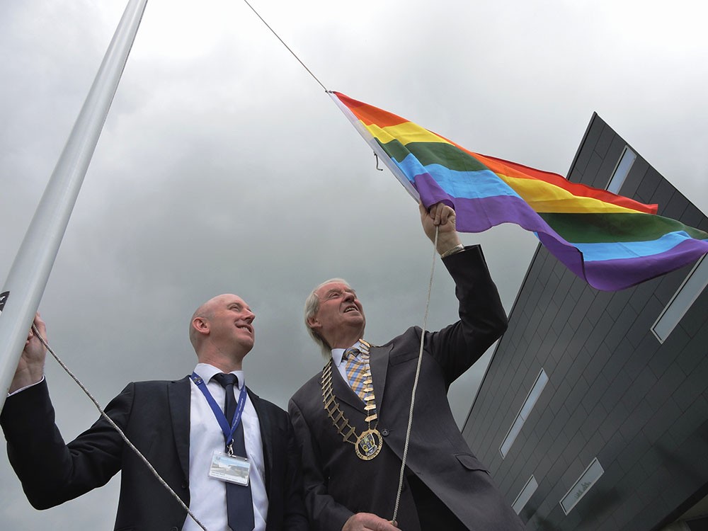 Councillor James Breen, Cathaoirleach of Clare County Council and Jason Murphy, Senior Executive Officer, Clare County Council raise the Pride Flag