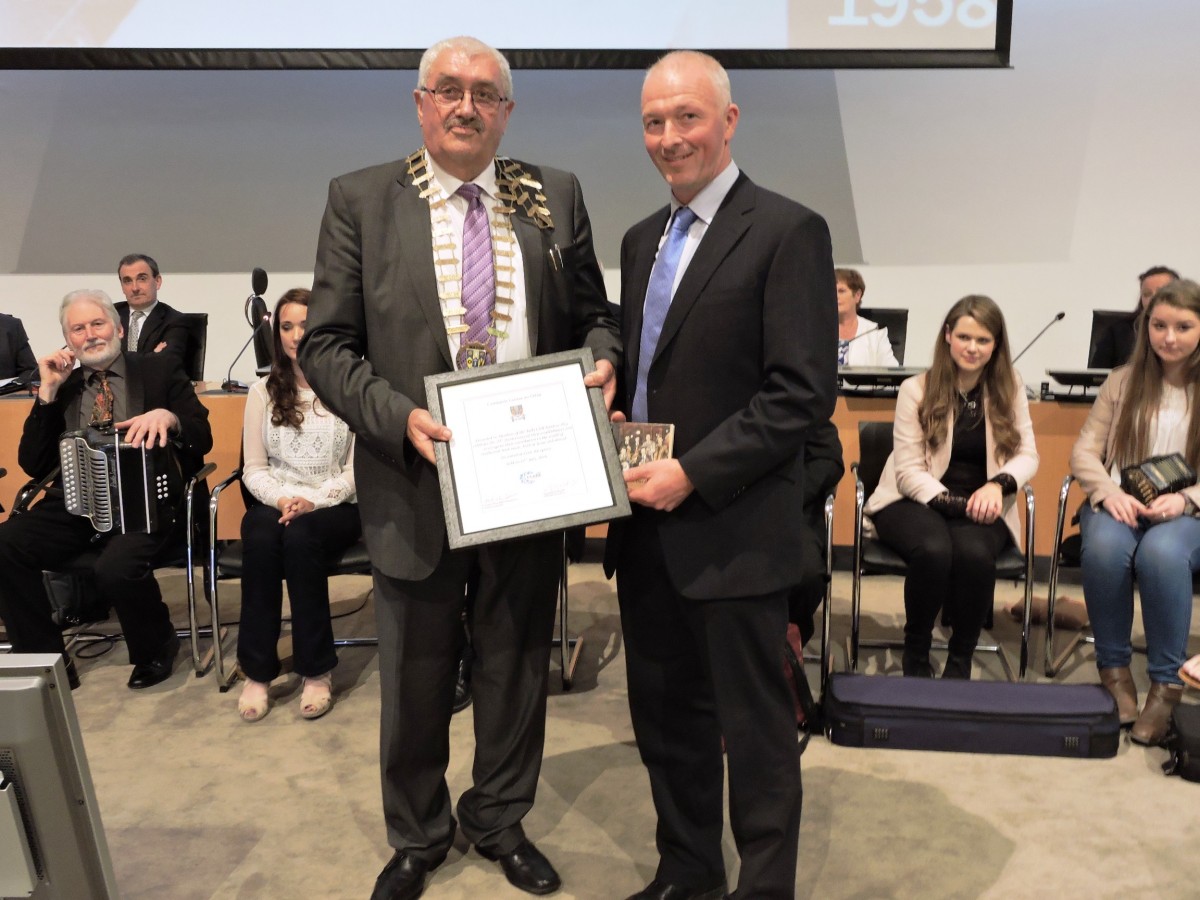 Councillor Bill Chambers, Cathaoirleach of Clare County Council presents Mark Donnellan, Leader of the Tulla Céilí Band with a framed scroll marking the occasion of the Irish traditional music group's Civic Reception.