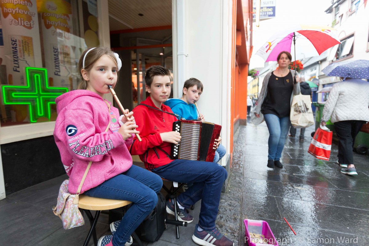 Musicians take shelter outside Cassidy's Pharmacy. Pic: Eamon Ward