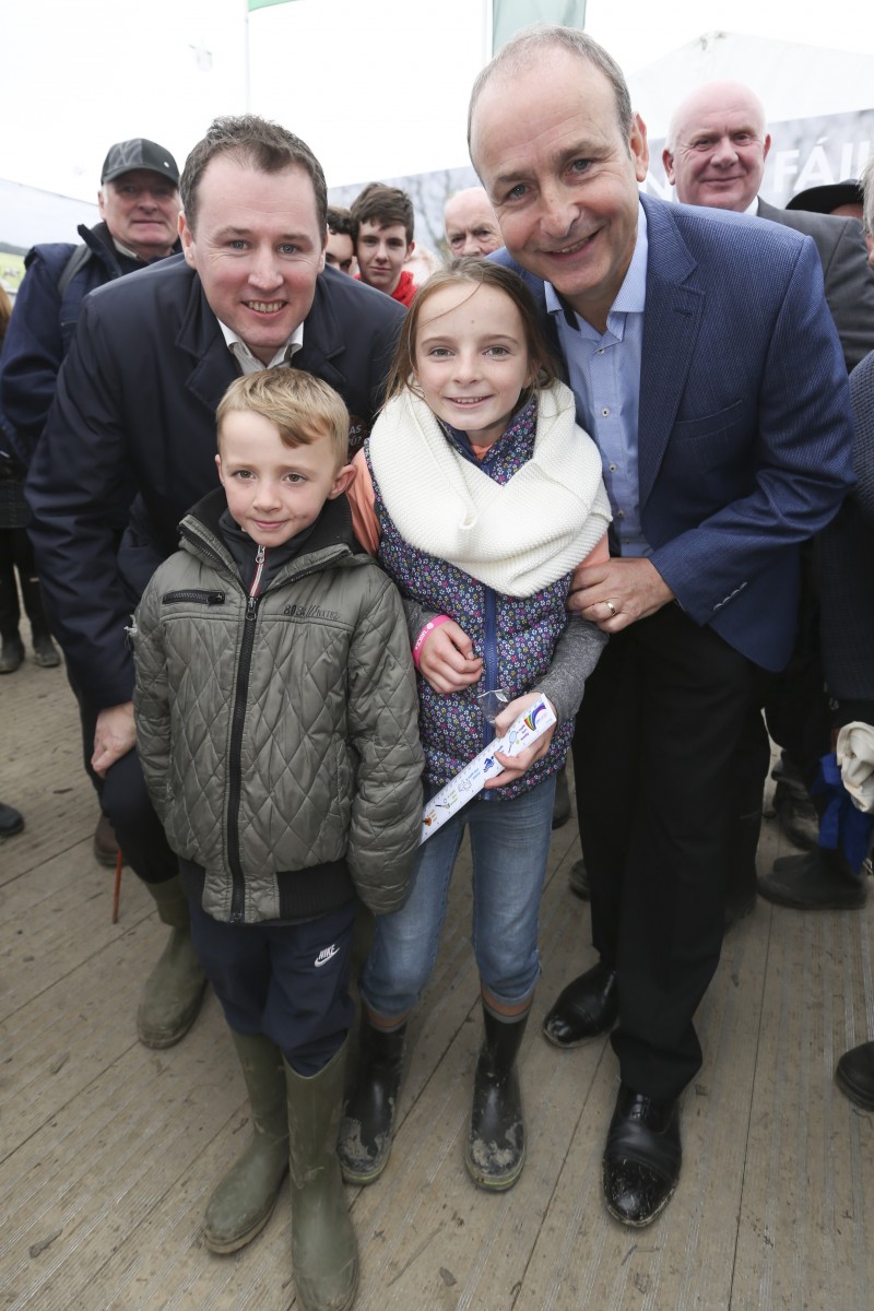 Fianna Fáil Leader, Micheál Martin TD, and Agriculture Spokesperson, Charlie McConologue TD with Roisin (age 10) and Caoimhin (age 7) from Shannon, Co Clare at the 2016 National Ploughing Championships, Screggan, Tullamore, Co Offaly. Pic: Conor McCabe