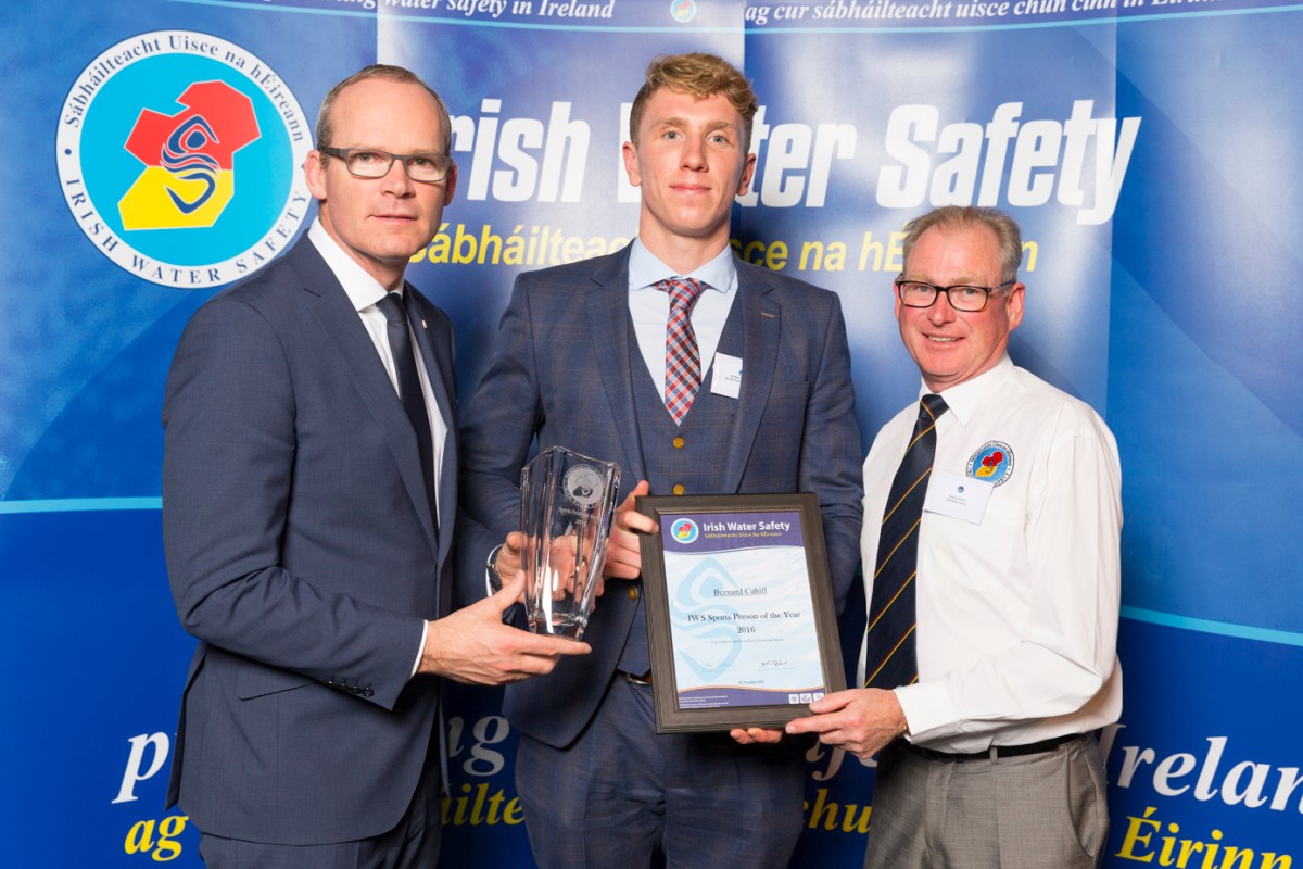 Minister Simon Coveney and Seamus O’Neill, IWS,  presenting Clare County Council lifeguard Bernard Cahill with the IWS Sports Person of the Year award.