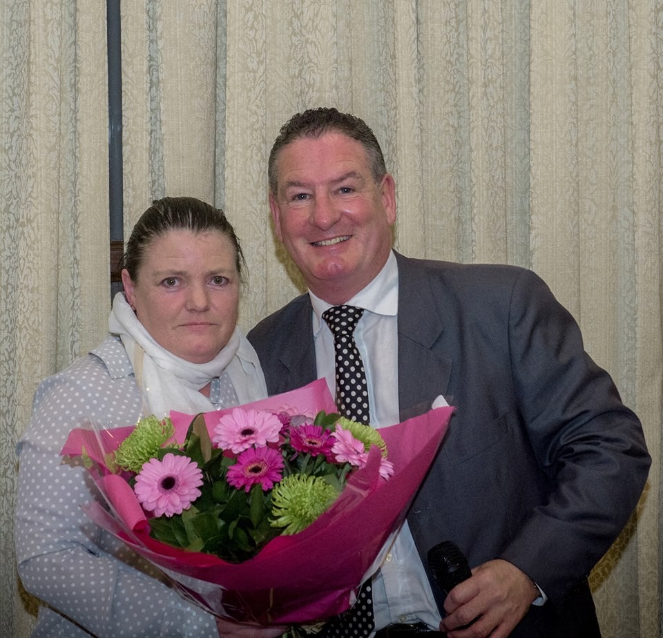 Brid MacNamara receives a bouquet of flowers from Joe Robbins in acknowledgment of her service to Clare Camogie. Pic: Martin Connolly