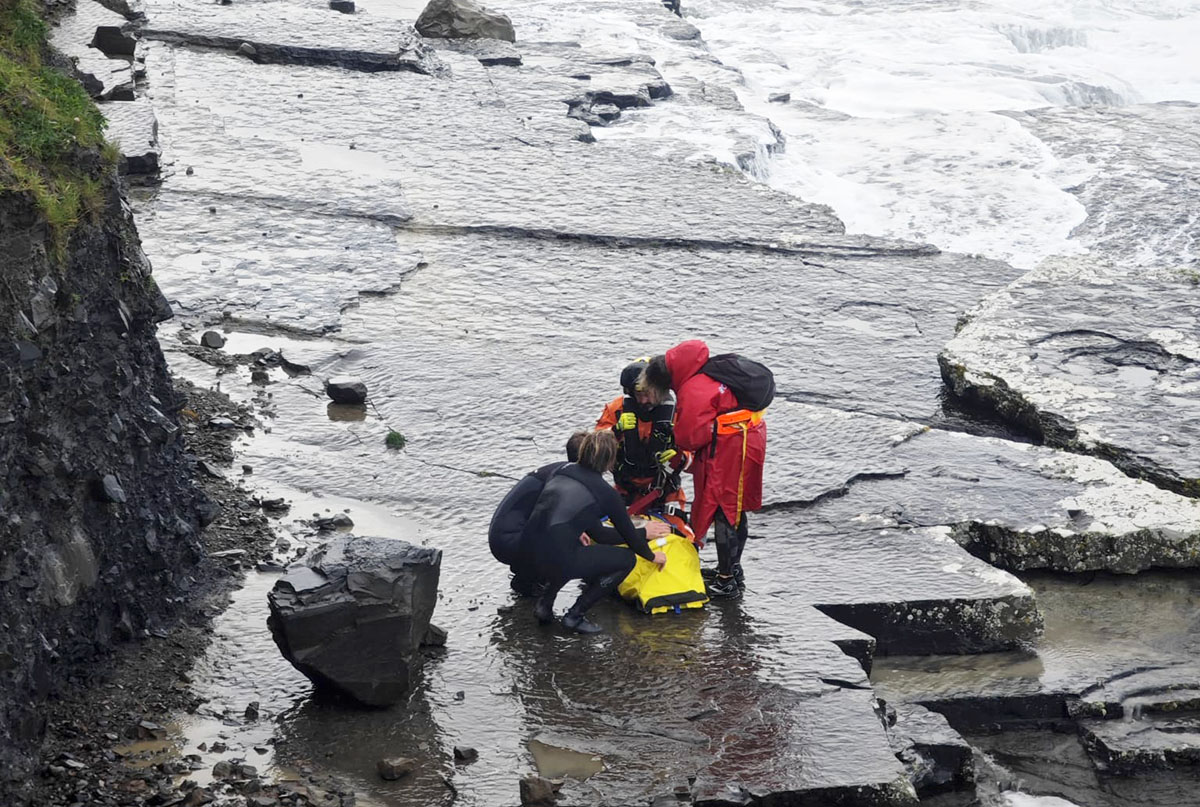 Woman and dog rescued after being cut off by tide